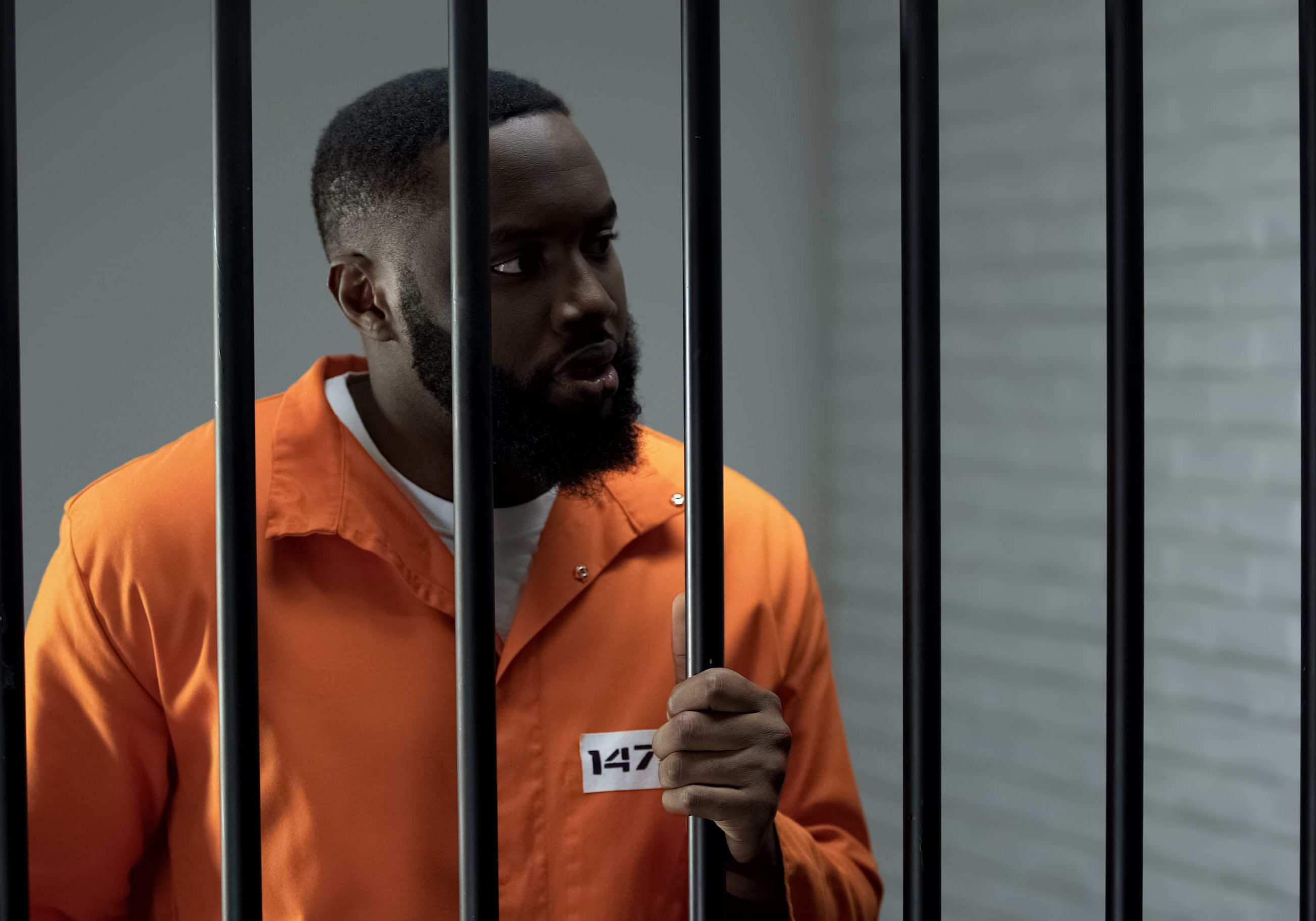 Aggressive prisoner holding bars and waiting for guard, inadequate criminal
